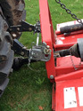 Easy-Change Hitching System installed on a red farm implement attached to the back of a tractor.