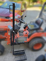 Orange & black lawn tractor with Homemade Small-tractor Powerlift Step bolted to it. Red car in background